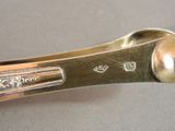 a silver spoon with a handle on a table