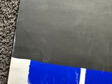 a close up of a piece of paper with blue paint on it