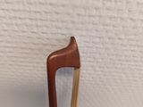 a small wooden stick sticking out of a piece of wood