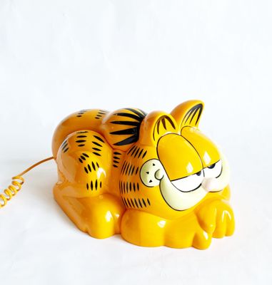 a yellow tiger figurine on a white background