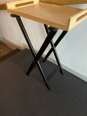 a wooden tray with a laptop on it sitting on a stand