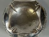 an image of a silver bowl on a table with a white background
