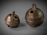 pair of bronze bells with the word ' s name on them