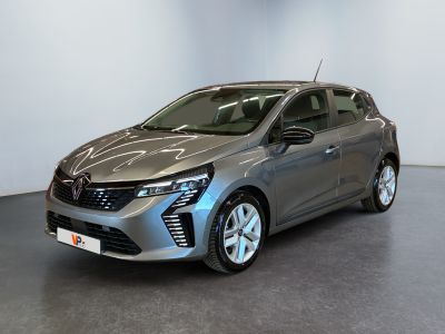 a grey car is parked in a room with a white wall