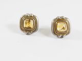 une paire de boucles d'oreilles en or et en argent sur fond blanc