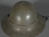 an old army helmet is sitting on top of a table