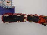 two toy trains sitting next to each other on a table
