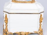 a white and gold box with a picture of a woman on it