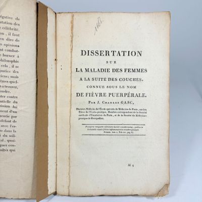 a book open on a table with a white background