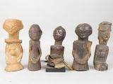 several wooden figurines of different shapes and sizes on a white surface