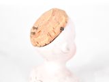 a small figurine with a cork hat on top of it