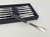 silverware in a black box on a white surface with a knife