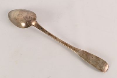 a spoon that is sitting on a white surface