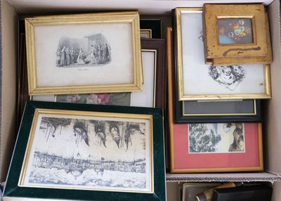 de nombreuses photos encadrées dans une boîte posée par terre