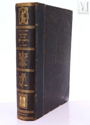 an old book sitting on top of a white table next to a white wall