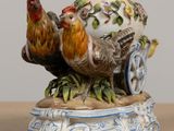 a figurine of a rooster and a chicken on a cart