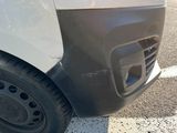 a close up of a car ' s front bumper with a hole in it