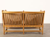 an image of a wooden bench with two cushions on top of it