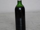 a bottle of wine sitting on a marble counter top