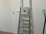 a ladder that is leaning against a wall in a room