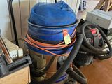 a vacuum that is sitting on the floor next to other items