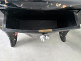 a small black table with a drawer on it