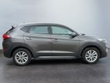 2020 hyundai tucson parked in a parking lot with a cloudy sky in the background