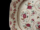 a plate with a floral design on it on a black background