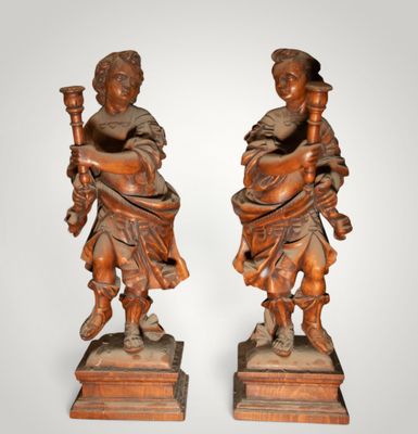 pair of carved wood figures of a boy and a girl