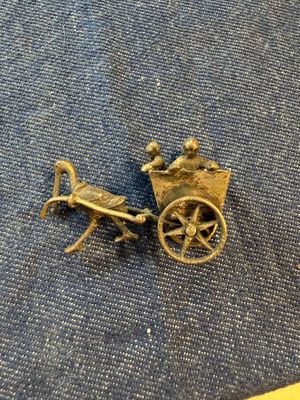 a small bronze figurine of a horse pulling a carriage