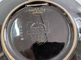 a close up of a black plate with a gold rim