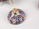 three ceramic figurines that are sitting on a table