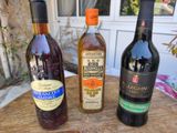 three bottles of wine sitting on a wooden table