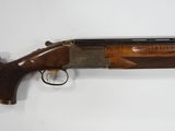 a shotgun that is on display on a wall