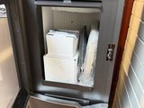 a refrigerator with a freezer inside of it in a room