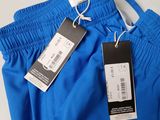 the back of a pair of blue pants with a price tag on it