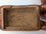 a small wooden box with a handle in the middle
