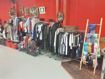 a room filled with lots of clothes and other items