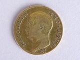 a gold coin with a picture of a man ' s face on it