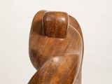 wooden sculpture of a woman ' s torso on a white pedestal