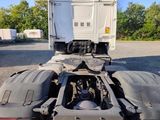 a truck that is parked in a lot with the back end of it