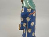 a figurine of a woman in a blue dress