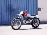 a white and red motorcycle parked in front of a blue building