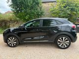 a picture of a black car parked in a driveway