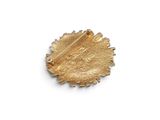 an image of a gold plated brooch with a face on it