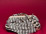 a black and white purse with a chain on top of it