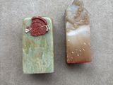 two soap bars with a wax seal and a wax seal on them
