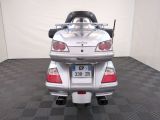 a picture of a silver motorcycle parked in a room
