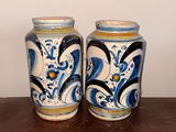 pair of blue and white vases sitting on top of a wooden table