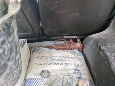 a bag of cement in the back seat of a car